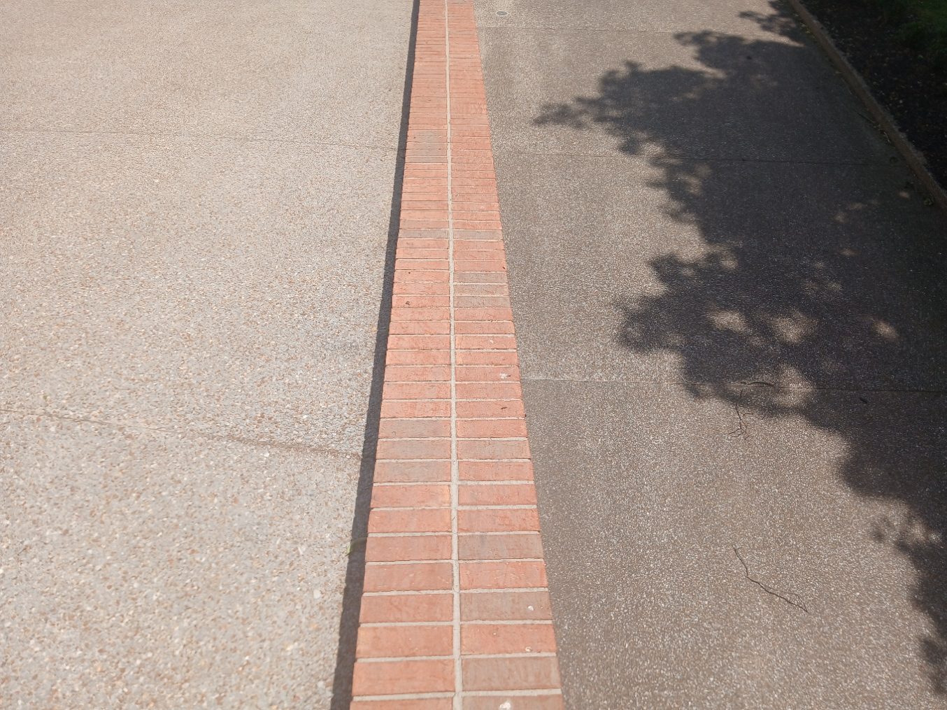 Driveway showing a crisp clean line between washed and unwashed concrete